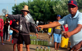 Men offer gasoline for sale on the streets of Maracaibo, Zulia State, Venezuela.