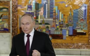 Russia's President Vladimir Putin meets with members of the media after addressing participants of the VTB Investment Forum "Russia Calling!" in Moscow on December 2, 2025. (Photo by SERGEI ILNITSKY / POOL / AFP)