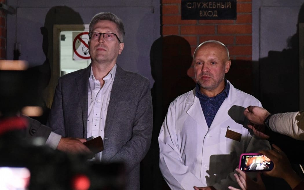 Boris Teplykh, left, and Anatoliy Kalinichenko, deputy chief doctor of the City Clinical Emergency Hospital Number 1, speak to the press after Russian opposition leader Alexei Navalny fell ill \