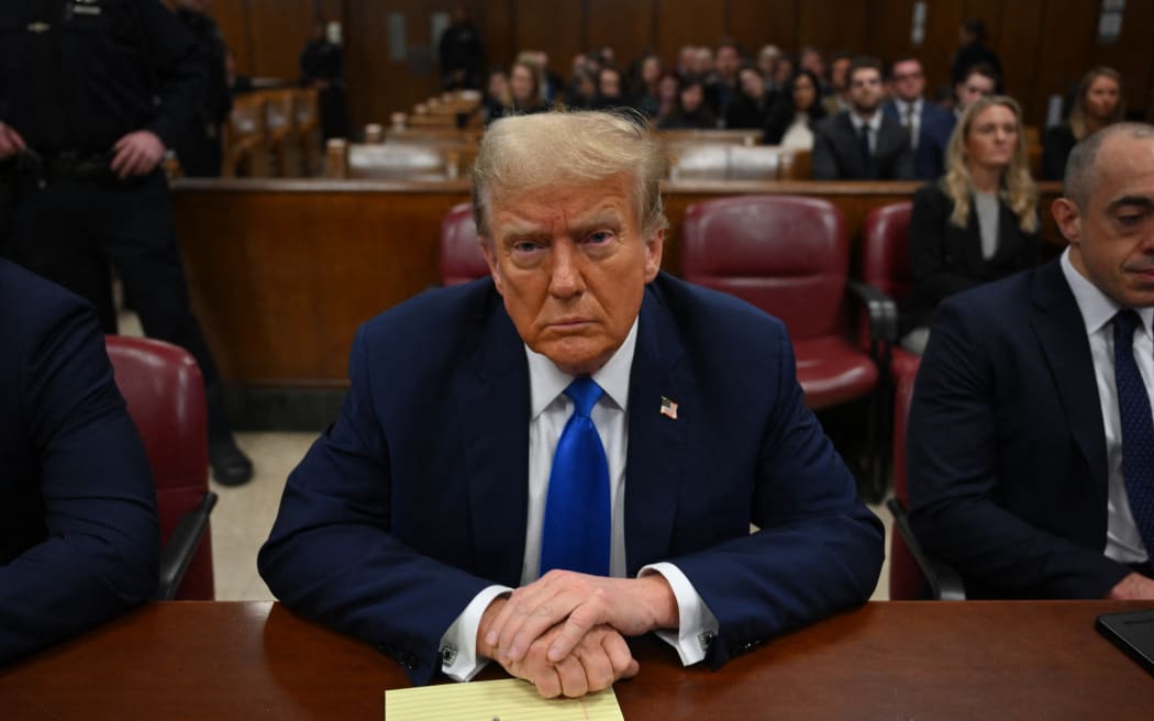 Former US president and Republican presidential candidate Donald Trump looks on at Manhattan Criminal Court during his trial for allegedly covering up hush money payments linked to extramarital affairs in New York on April 22, 2024. Donald Trump's unprecedented criminal trial is set for opening statements after final jury selection ended Friday, leaving the Republican presidential candidate facing weeks of hostile testimony that will overshadow his White House campaign. (Photo by ANGELA WEISS / POOL / AFP)
