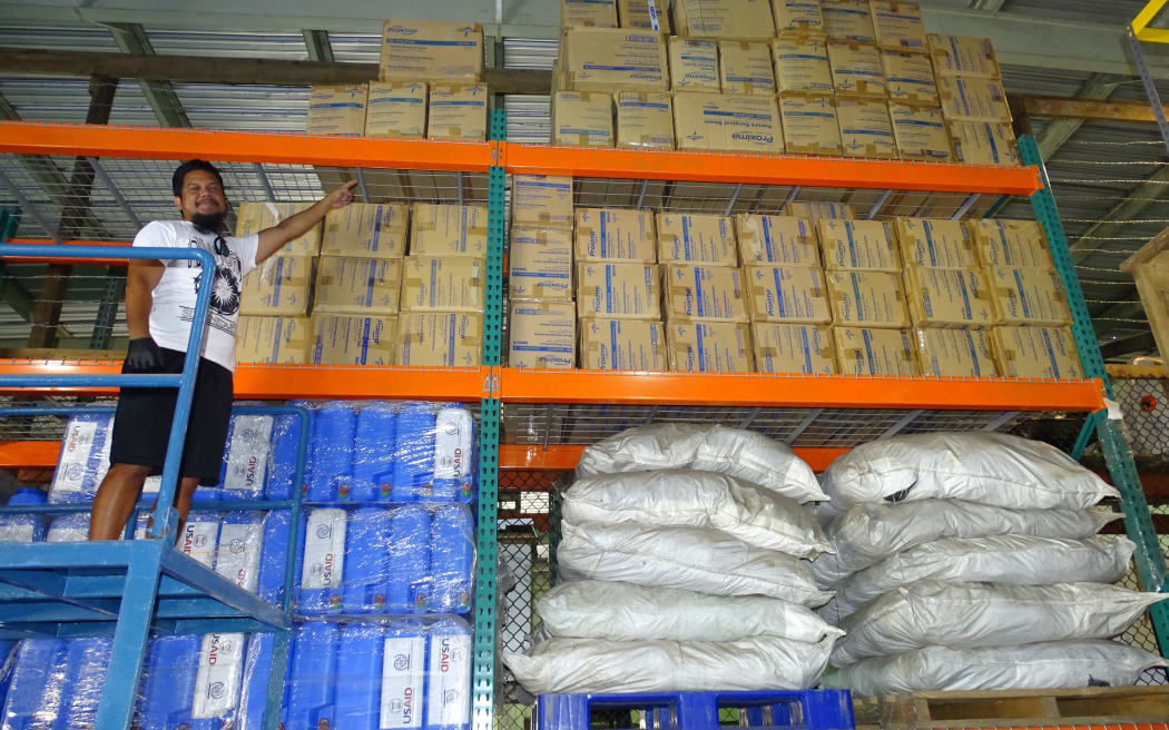 Marshall Islands Ministry of Health worker Mackneil Abraham points to boxes of recently arrived personal protection equipment being stored in anticipation of a future outbreak of Covid-19 in the country.