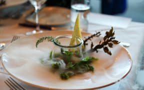 Scallops and poached eggs with syphon holandaise on a bed of sea lettuce with dry ice