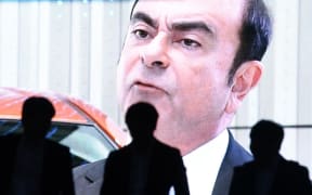 An image of Carlos Ghosn on a large screen in Tokyo
