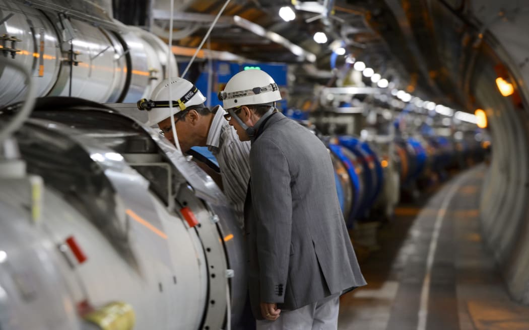 Scientists inspect the inner workings of the Large Hadron Collider.
