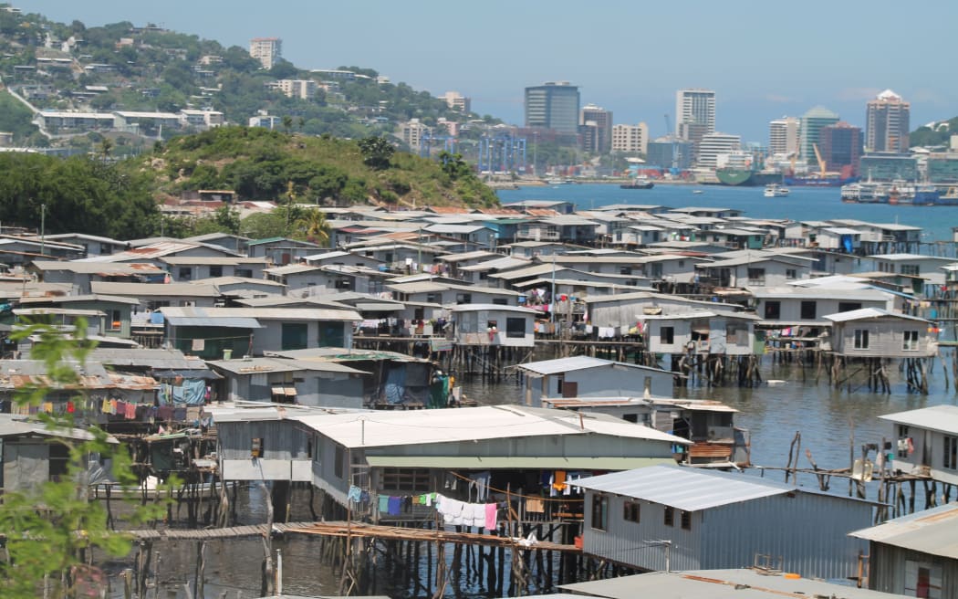 Hanuabada, the original village of Papua New Guinea's capital city Port Moresby inhabited by the Motuan people; with the CBD in the background.