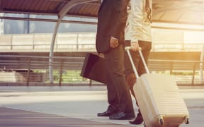 Businessman and businesswoman traveler with luggage at city background, Business People Commuter Walking City Life Concept.