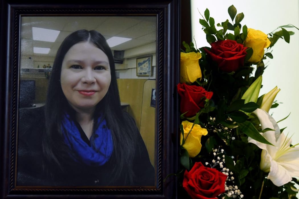 View of a portrait of Salvadorean journalist Karla Lisseth Turcios is shown next to her coffin during her funeral in San Salvador, on April 16, 2018.