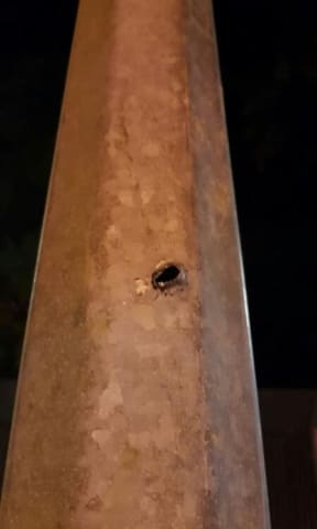 A bullet hole in a post at the Manus Island detention centre.