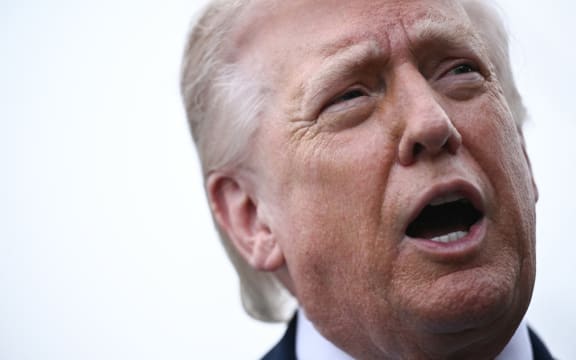 US President Donald Trump speaks to journalists before boarding Marine One as he departs from the South Lawn of the White House in Washington, DC, on 20 March, 2026.