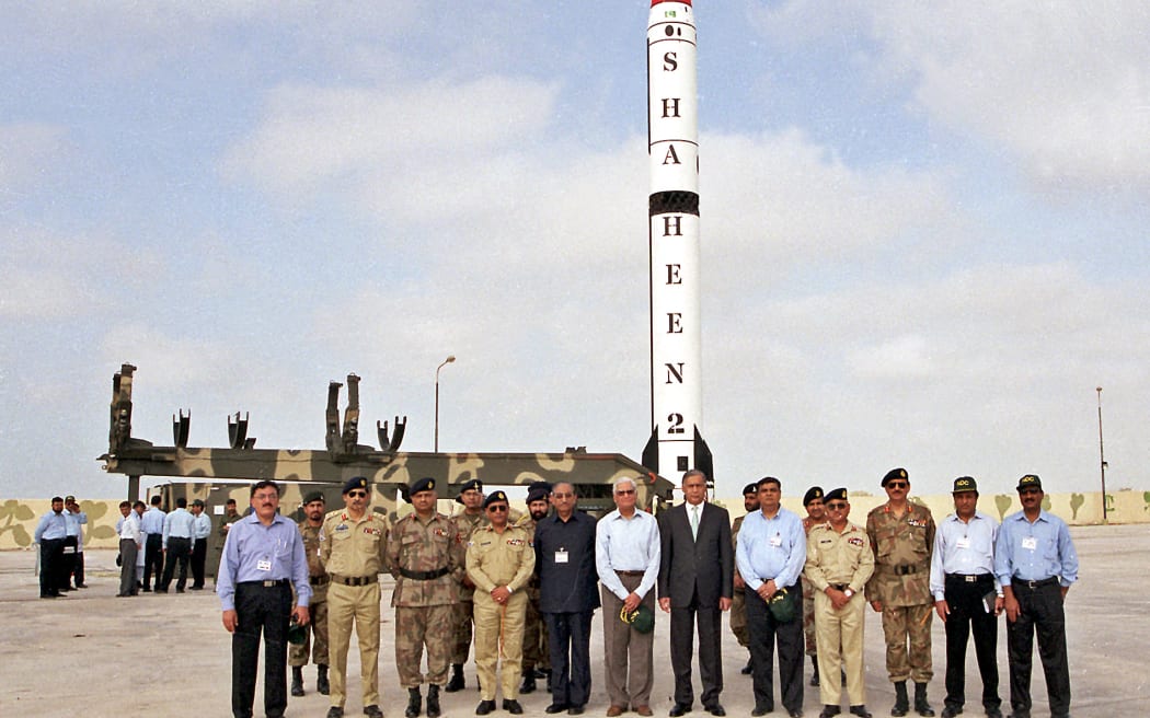 Pakistani Prime Minister Shaukat Aziz (6R) stands with officials in front of the nuclear-capable missile Hatf VI (Shaheen II) prior to its test fire at an undisclosed location, 29 April 2006. Pakistan 29 April successfully test fired a nuclear capable missile with a range of 2,000 kilometers (1,250 miles), the military said. It was the second test firing of the surface-to-surface Hatf VI (Shaheen II) missile, which was earlier tested in March 2005.       AFP PHOTO/HO/INTER SERVICES PUBLIC RELATIONS--RESTRICTED TO EDITORIAL USE---- (Photo by ISPR / INTER SERVICES PUBLIC RELATIONS / AFP)