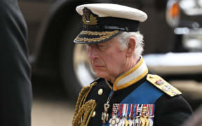 Britain's King Charles III follows the coffin of Queen Elizabeth II, as it travels on the State Gun Carriage of the Royal Navy, from Westminster Abbey to Wellington Arch in London on September 19, 2022, after the State Funeral Service of Britain's Queen Elizabeth II.