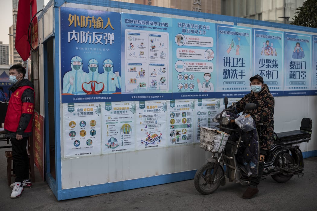 Information posters encouraging people to wash their hands and wear masks, outside a shopping mall in Wuhan. 13, January, 2021.
