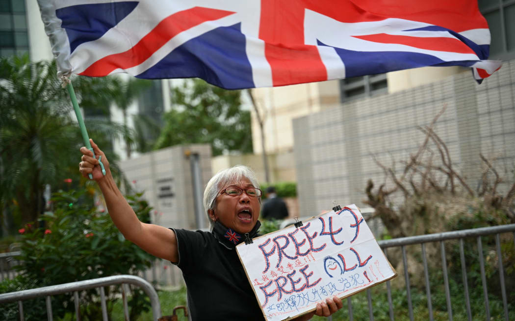 Pro-democracy activist known as Grandma Wong protests outside the court where Hong Kong's largest national security trial against 47 pro-democracy activists started its final arguments on November 29, 2023 more than 1,000 days since the case under the Beijing-imposed law began. (Photo by Peter PARKS / AFP)