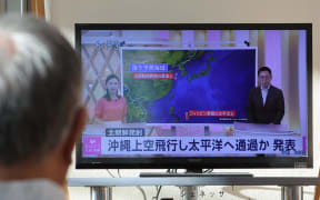 A man watches a news on North Korea at the Naha Airport in Naha City, Okinawa Prefecture on Aug. 24, 2023. The government announced that a possible ballistic missile was launched from North Korea. The missile was believed to have passed into the Pacific Ocean. North Korea said that their second spy satellite launch failed and will try again in October. ( The Yomiuri Shimbun ) (Photo by Daisuke Urakami / Yomiuri / The Yomiuri Shimbun via AFP)