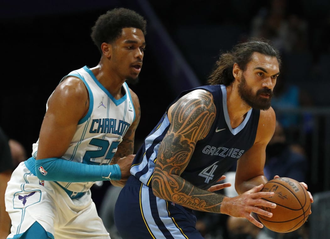 Steven Adams #4 of the Memphis Grizzlies posts up against P.J. Washington #25 of the Charlotte Hornets during the first period of their game at Spectrum Center on October 07, 2021 in Charlotte, North Carolina.