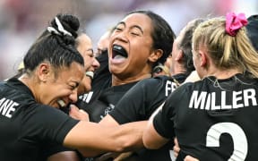 New Zealand's players celebrate after the women's gold medal rugby sevens match between New Zealand and Canada during the Paris 2024 Olympic Games at the Stade de France in Saint-Denis on July 30, 2024. (Photo by CARL DE SOUZA / AFP)