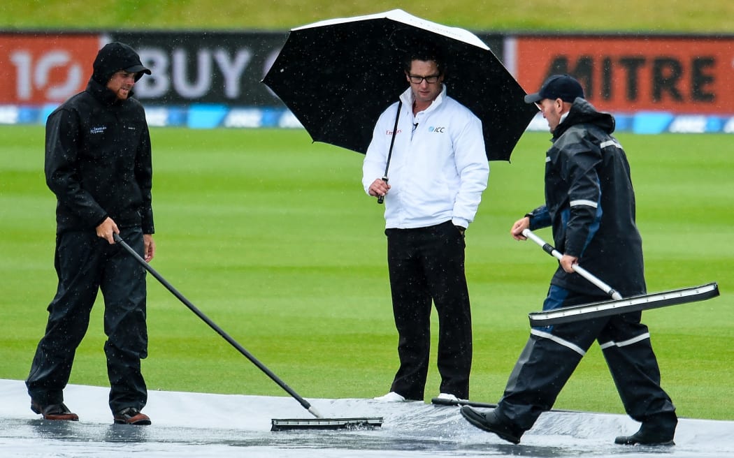 3rd Umpire Marais Erasmus checks out the wicket block with the groundsman.