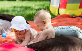 babies playing together (stock photo)