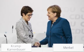 German Chancellor and Chairwoman of the Christian Democratic Union (CDU) Angela Merkel (R)greets CDU Secretary General Annegret Kramp-Karrenbauer (L) during the 31. Party Congress in Hamburg, Germany on December 7, 2018. AFP