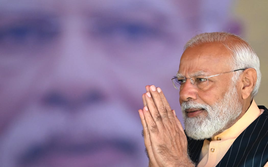 India's Prime Minister Narendra Modi greets his supporters on his arrival at the public meeting organised by Bharatiya Janata Party (BJP) in Barasat on the outskirts of Kolkata on March 6, 2024.
DIBYANGSHU SARKAR / AFP