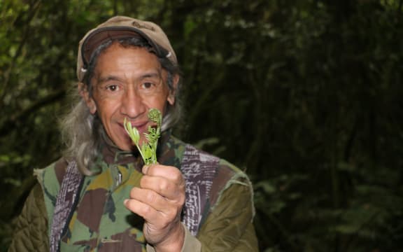 Charles with a pikopiko (fern) in Hinehopu forest, Rotoiti.