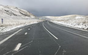 Snow covers hills near Lake Tekapo.