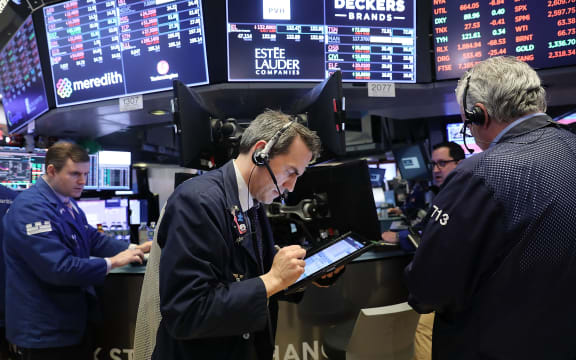 Traders work on the floor of the New York Stock Exchange for Tuesday trading.