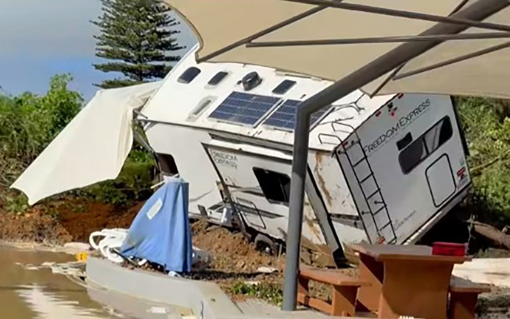 This screen grab made from UGC footage courtesy of Facebook user Dion Siluch taken and released on January 22, 2026 shows the aftermath of a landslide at Mount Hot Pools in Mount Maunganui. A landslide smashed into a campsite in rain-swept northern New Zealand on January 22 leaving multiple people missing, police and rescuers said. (Photo by Handout / Courtesy of Facebook user Dion Siluch / AFP) / RESTRICTED TO EDITORIAL USE - MANDATORY CREDIT "AFP PHOTO /  COURTESY OF FACEBOOK USER DION SILUCH" - HANDOUT - NO MARKETING NO ADVERTISING CAMPAIGNS - DISTRIBUTED AS A SERVICE TO CLIENTS