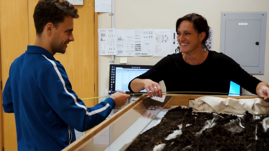 Chalie Charlick and Karin Konold measuring cloak draws.