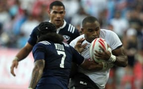 Isake Katonibau of Fiji charges forward against USA at the Singapore Sevens.