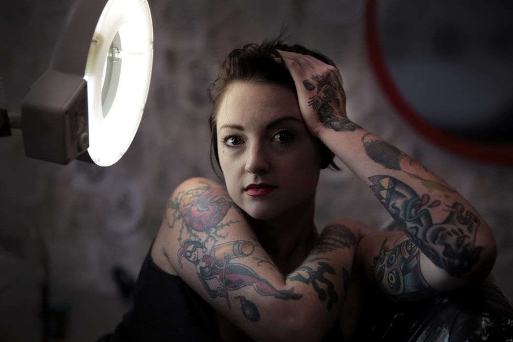 A portrait of Char, showing her tattoos