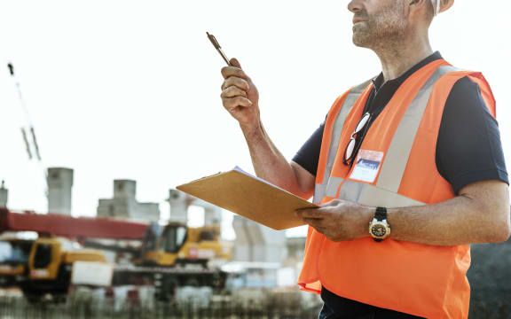 Man in high vis gear at building site.Architecture, Construction Safety, First Concept image.