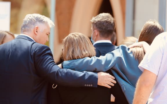 Diane Hunt, mother of slain police officer Matthew Hunt, centre, is supported by family after speaking outside court where her son's killer was sentenced.