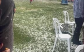 Cup Week patrons scramble for cover during a hailstorm at Riccarton Park.