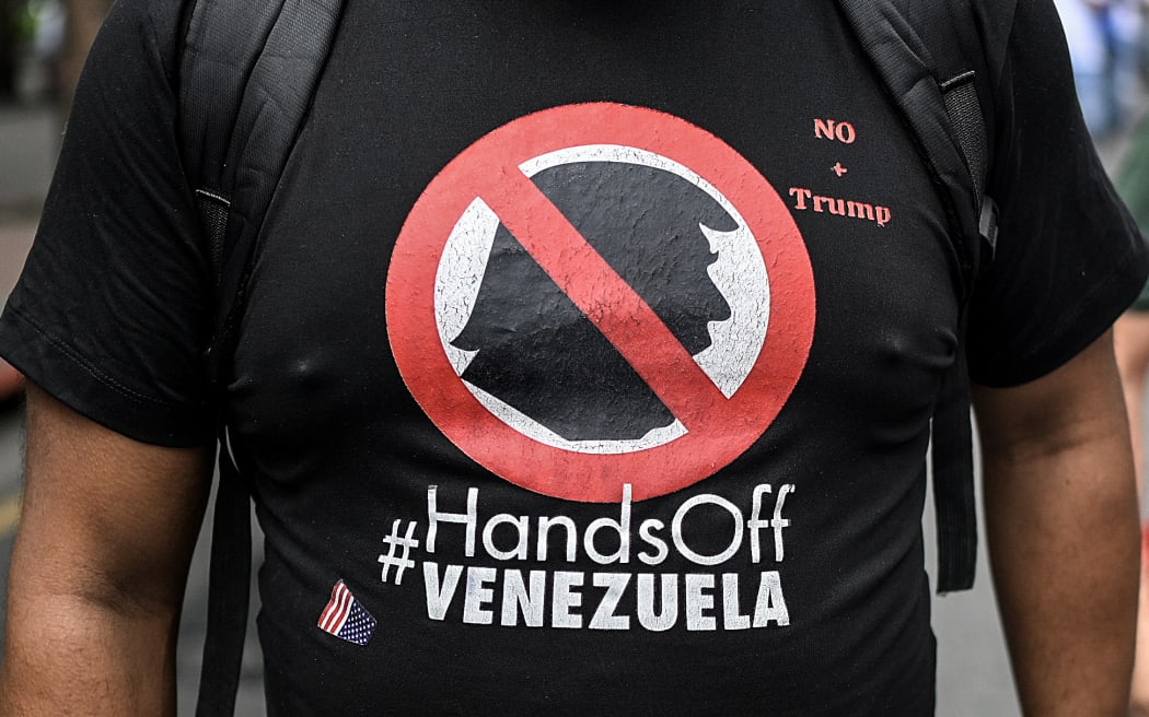 A t-shirt depicting US President Donald Trump that reads 'Hands off Venezuela' is seen while supporters of Venezuela's President Nicolas Maduro take part in a protest against the reward imposed by the US President, in Caracas on 11 August 11, 2025.