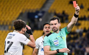 Referee Ben Abraham shows a red card to Logan Rogerson of Auckland during the A-League Men - Phoenix v Auckland FC at Sky Stadium, Wellington.