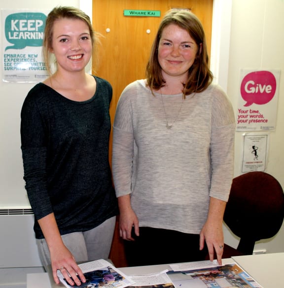 A photo of Brooke Gray on the left and herstory founder, Chrissy Irvine, looking at some of Brooke's photos