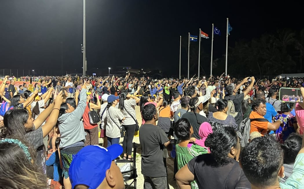 Waylon Mueller, the Marshall Islands' most decorated athlete in history, carries the torch and lights the Games flame during the opening ceremony of the Micronesian Games.