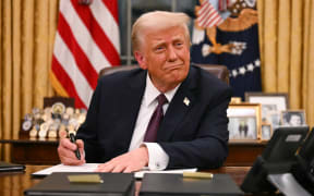 US President Donald Trump signs executive orders in the Oval Office of the White House in Washington, DC, on 20 January 2025. (Photo by Jim WATSON / POOL / AFP)