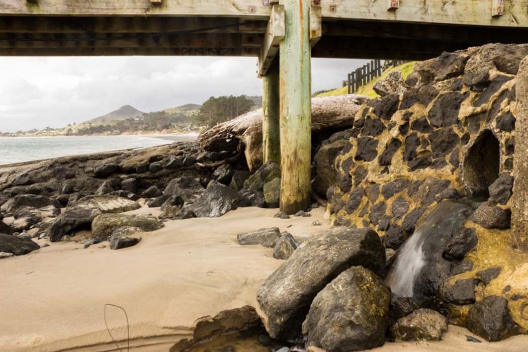 A stormwater drain runs into the beach in Rawene.