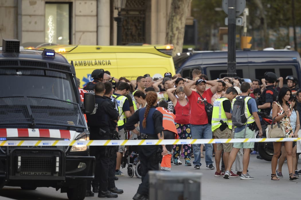 Policemen check the identity of people standing with their hands up after a van ploughed into the crowd.