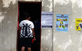 Voter waits to choose a candidate for the snap election in Port Vila.