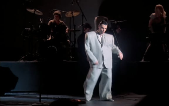 still image from the Talking Heads film 'Stop Making Sense': David Byrne dancing in his "big suit".