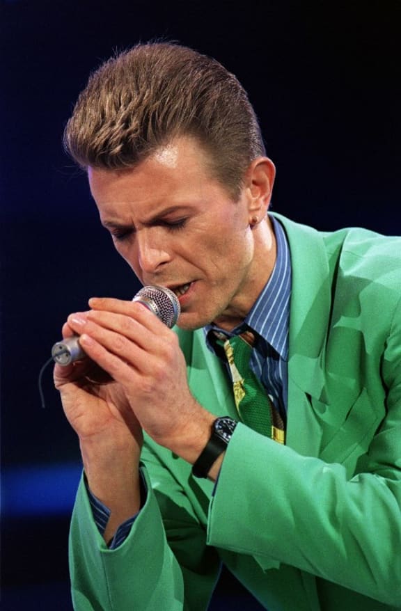 David Bowie says a prayer for Freddie Mercury after singing a song in front of the 72,000 people gathered, 20 April 1992 at Wembley Stadium, in London to attend the Aids benefit concert.