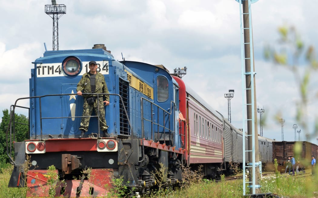 The train carrying bodies from Flight MH17 arrives at the government-held city of Kharkiv.