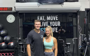 Jon and Livi Kitson-Clark stand inside their gym.