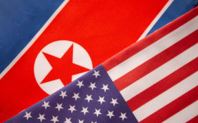 The North Korean and US flags.