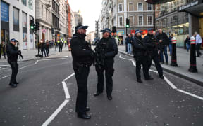 Armed policman stand guard at Cannon Street station in central London, on November 29, 2019 after reports of shots being fired on London Bridge.