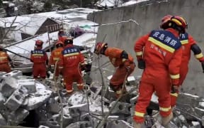 This screenshot captured on Jan. 22, 2024 shows rescuers working at the site of a landslide in Liangshui Village, Tangfang Town in the city of Zhaotong, southwest China's Yunnan Province.