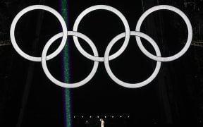 Canadian singer Celine Dion performs on the Eiffel Tower during the opening ceremony of the Paris 2024 Olympic Games in Paris on July 26, 2024. (Photo by Loic VENANCE / POOL / AFP)
